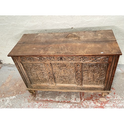 399 - A 16th century heavily carved oak coffer - approx. 82cm high x 123cm wide x 51cm deep