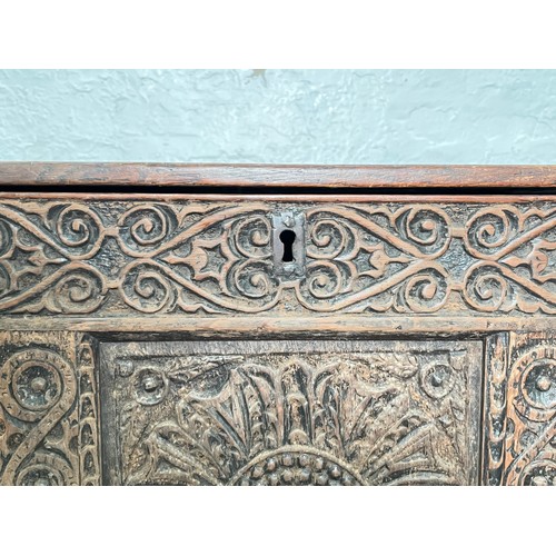 399 - A 16th century heavily carved oak coffer - approx. 82cm high x 123cm wide x 51cm deep