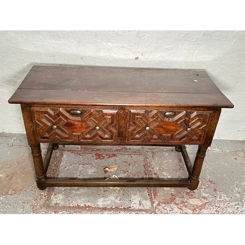 378 - A 17th century and later oak geometric moulded two drawer hall table - approx. 74cm high x 129cm wid... 