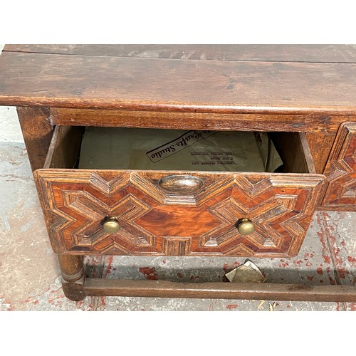 378 - A 17th century and later oak geometric moulded two drawer hall table - approx. 74cm high x 129cm wid... 