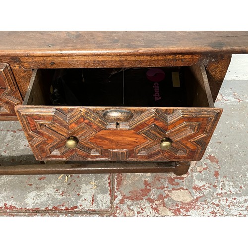 378 - A 17th century and later oak geometric moulded two drawer hall table - approx. 74cm high x 129cm wid... 