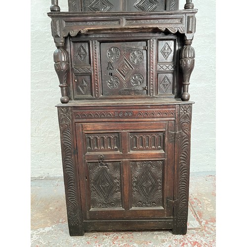 369 - An Elizabethan and later carved oak court cupboard with acanthus leaf design pillars, central cupboa... 