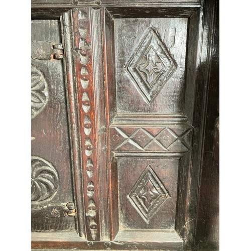 369 - An Elizabethan and later carved oak court cupboard with acanthus leaf design pillars, central cupboa... 