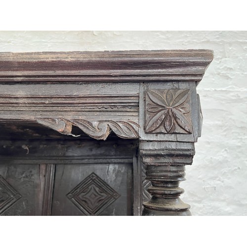 369 - An Elizabethan and later carved oak court cupboard with acanthus leaf design pillars, central cupboa... 