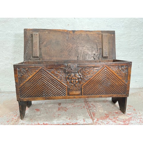 404 - A 17th century oak sword chest with carved cherub design - approx. 56.5cm high x 112cm wide x 39cm d... 