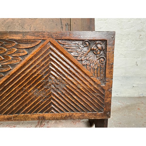 404 - A 17th century oak sword chest with carved cherub design - approx. 56.5cm high x 112cm wide x 39cm d... 