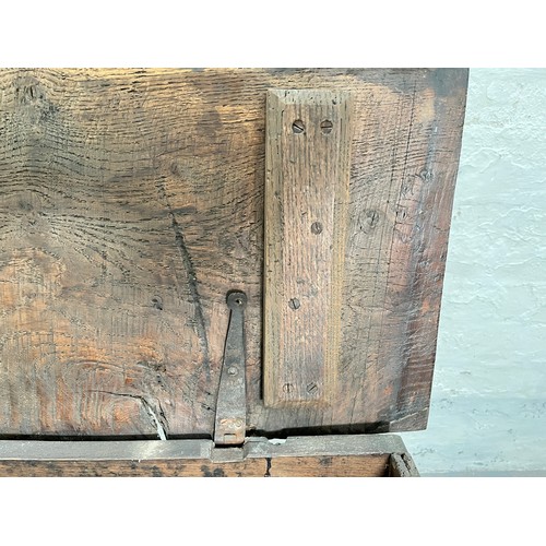 404 - A 17th century oak sword chest with carved cherub design - approx. 56.5cm high x 112cm wide x 39cm d... 