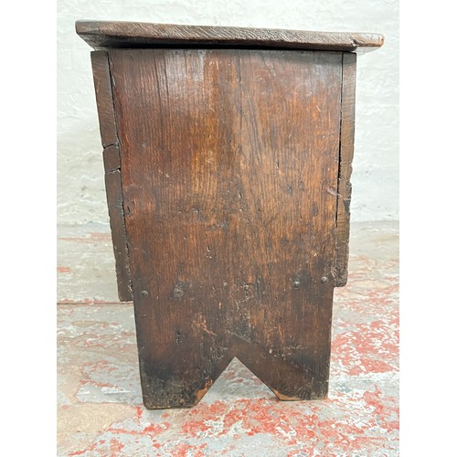 404 - A 17th century oak sword chest with carved cherub design - approx. 56.5cm high x 112cm wide x 39cm d... 