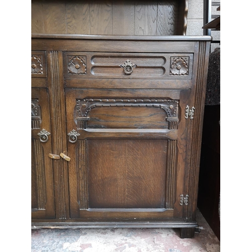 309 - A mid/late 20th century oak Welsh dresser with two upper leaded glass doors, two drawers and two low... 