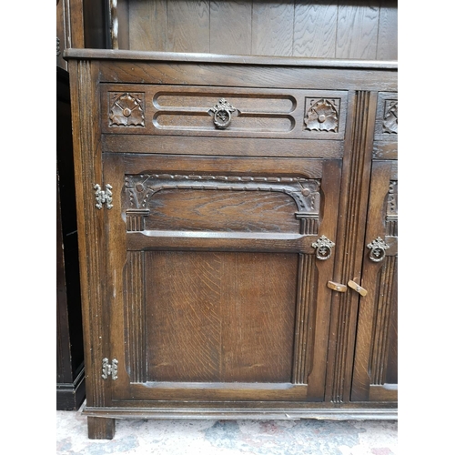 309 - A mid/late 20th century oak Welsh dresser with two upper leaded glass doors, two drawers and two low... 