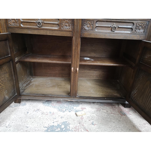 309 - A mid/late 20th century oak Welsh dresser with two upper leaded glass doors, two drawers and two low... 