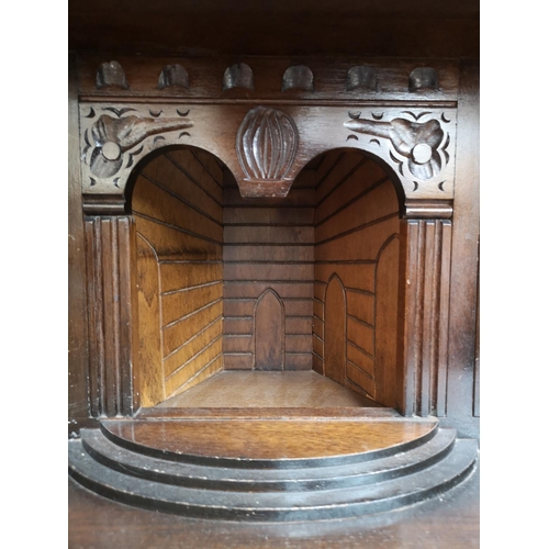 310 - A mid/late 20th century oak court cupboard with two upper leaded glass doors, two drawers and two lo... 