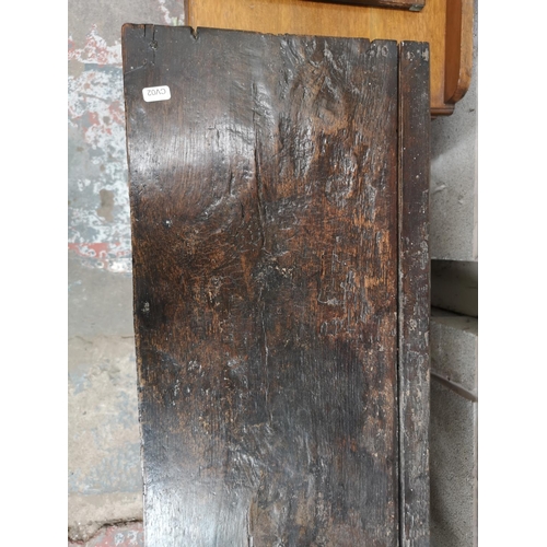 311 - A 17th century oak two door cupboard with Tudor Rose design - approx. 112cm high x 112cm wide x 31cm... 