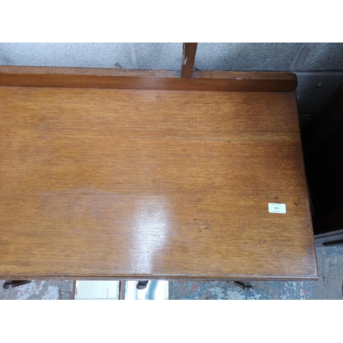 313 - An Art Deco oak dressing table with six short drawers, one long drawer, upper three section mirror a... 