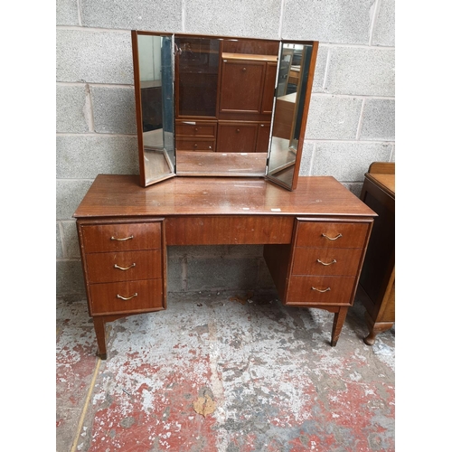 314 - A mid 20th century tola wood dressing table with six short drawers, one long drawer and upper three ... 