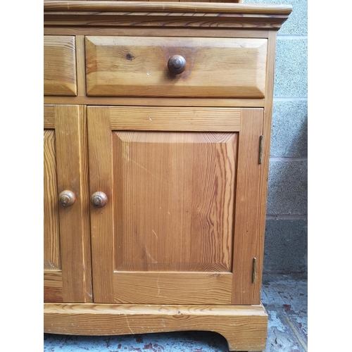 315 - A modern pine Welsh dresser with upper two tier plate rack, two drawers and two lower cupboard doors... 