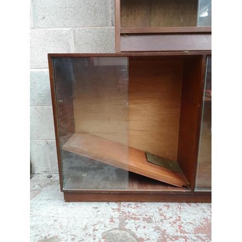 316 - Two mid 20th century tola wood bookcases with glass sliding doors, one approx. 84cm high x 76cm wide... 