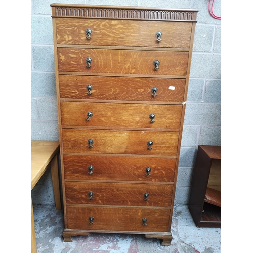 317 - A mid 20th century tall oak chest of eight drawers - approx. 184cm high x 91cm wide x 51cm deep