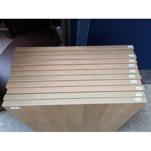 321 - Eleven modern oak effect square table tops - approx. 60cm square