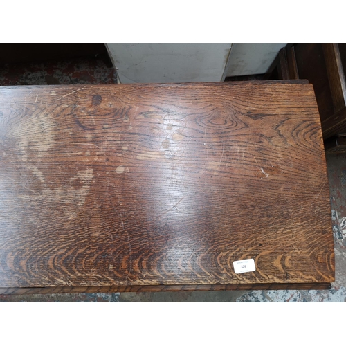 326 - An oak drop leaf gate leg oval dining table - approx. 76cm high x 109cm wide x 132cm extended