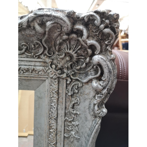 332 - A modern Louis XV style ornate framed bevelled edge wall mirror - approx. 130cm x 104cm