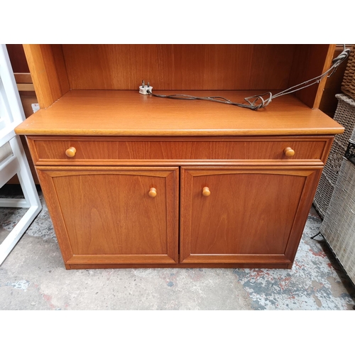 338 - A Morris of Glasgow teak display cabinet with two upper bevelled glass doors, one long drawer and tw... 