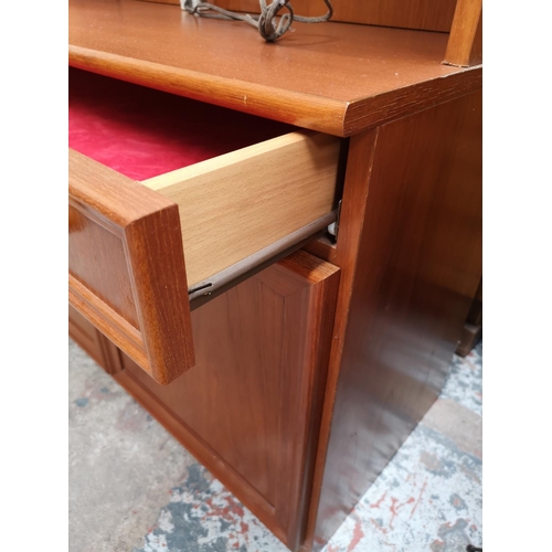 338 - A Morris of Glasgow teak display cabinet with two upper bevelled glass doors, one long drawer and tw... 