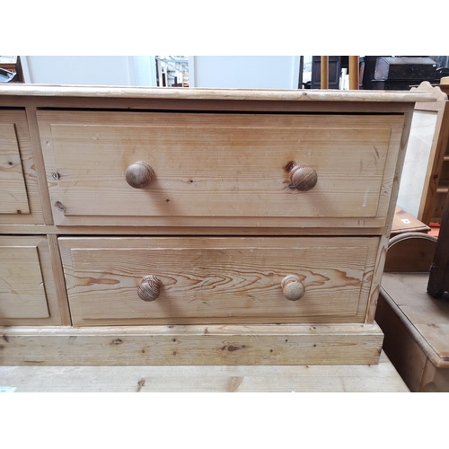 354 - A modern solid pine low chest of four drawers - approx. 57cm high x 135cm wide x 39cm deep