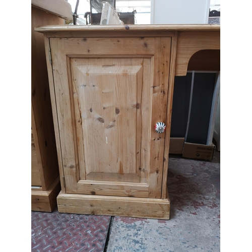 355 - A Victorian style solid pine pedestal desk with single cupboard door and four drawers - approx. 76cm... 