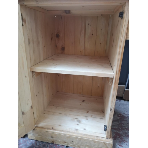 355 - A Victorian style solid pine pedestal desk with single cupboard door and four drawers - approx. 76cm... 