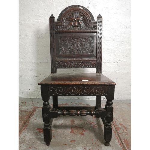 373 - A 19th century Gothic Revival carved oak side chair with lower stretcher and Green Man design - appr... 