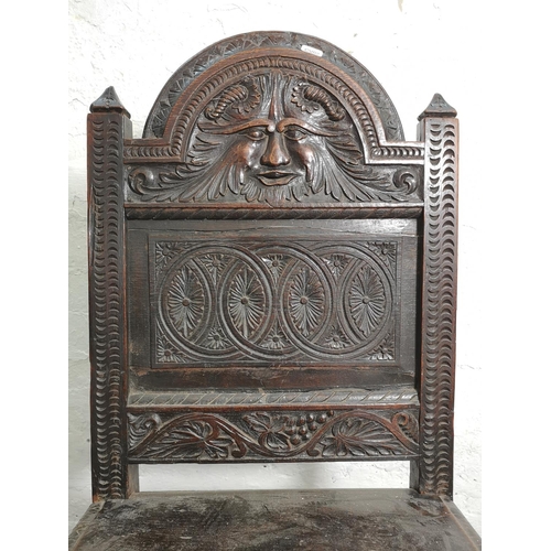 373 - A 19th century Gothic Revival carved oak side chair with lower stretcher and Green Man design - appr... 