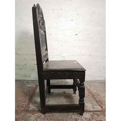 373 - A 19th century Gothic Revival carved oak side chair with lower stretcher and Green Man design - appr... 