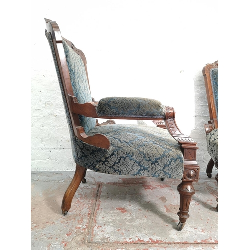 375 - A late Victorian carved walnut and blue upholstered three piece parlour suite comprising double spoo... 