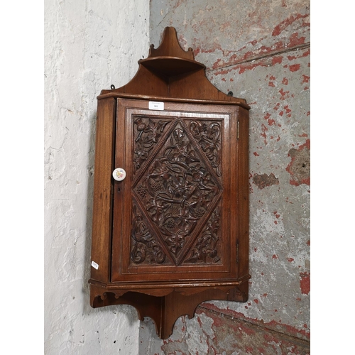 381 - An early 20th century carved mahogany wall mountable corner cabinet with single door - approx. 105cm... 