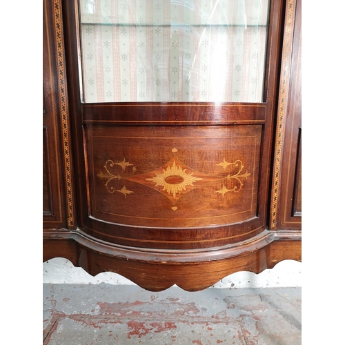 391 - An Edwardian inlaid mahogany bow fronted display cabinet with two glazed doors and three internal gl... 