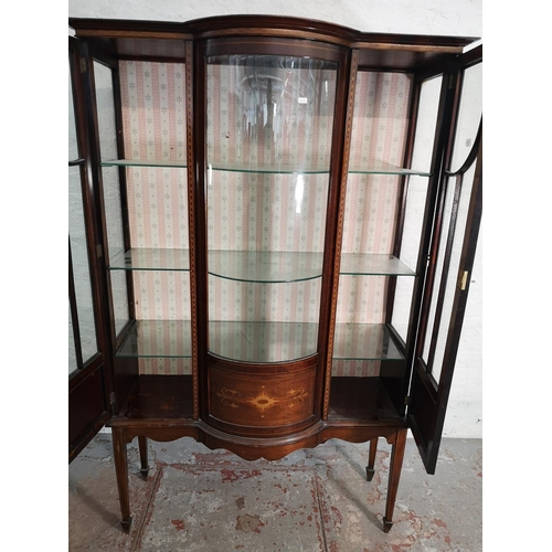 391 - An Edwardian inlaid mahogany bow fronted display cabinet with two glazed doors and three internal gl... 