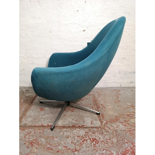 396 - A mid 20th century teal upholstered swivel armchair - approx. 89cm high x 82cm wide x 48cm deep