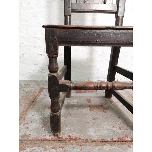 398 - A Georgian oak hall chair - approx. 116cm high x 45cm wide x 39cm deep