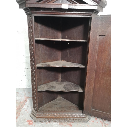 402 - An antique heavily carved oak wall mountable corner cabinet - approx. 99cm high x 57cm wide x 35cm d... 