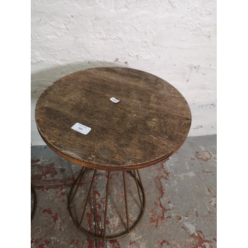 416 - A pair of modern hardwood and metal circular side tables - approx. 49cm high x 37cm diameter