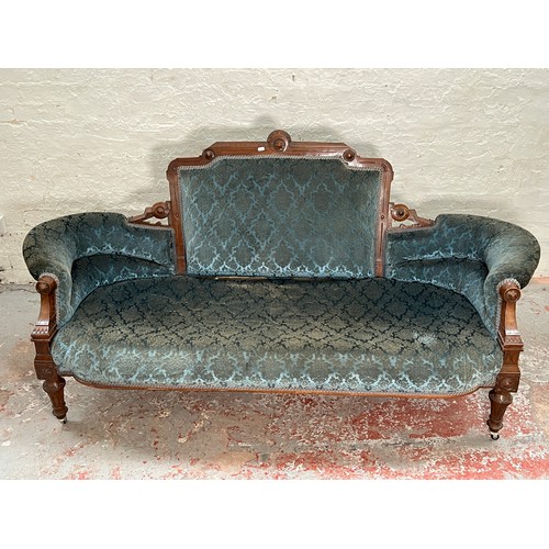 375 - A late Victorian carved walnut and blue upholstered three piece parlour suite comprising double spoo... 