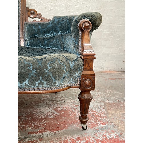 375 - A late Victorian carved walnut and blue upholstered three piece parlour suite comprising double spoo... 