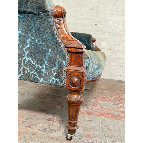 375 - A late Victorian carved walnut and blue upholstered three piece parlour suite comprising double spoo... 