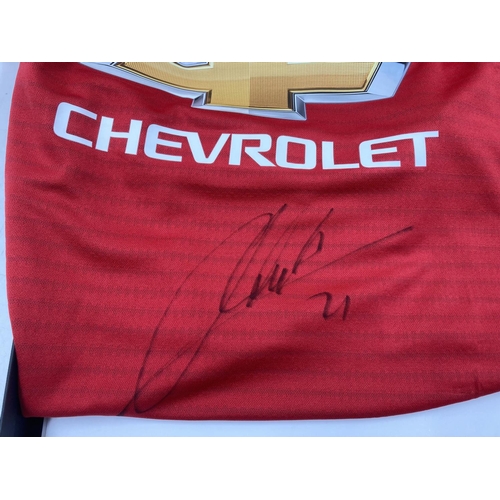 203 - A boxed Manchester United signed football shirt with certificate of authenticity