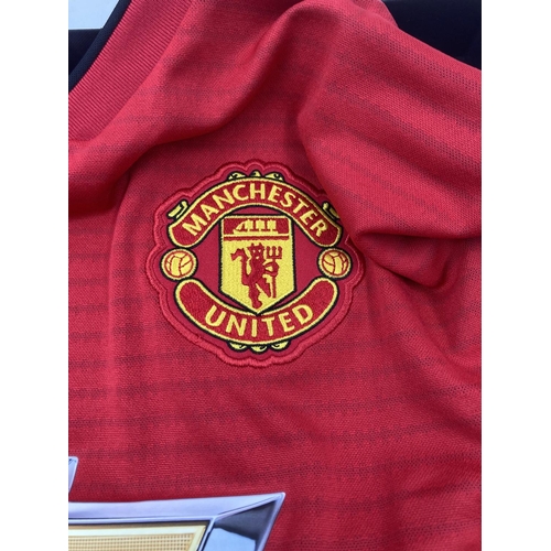 203 - A boxed Manchester United signed football shirt with certificate of authenticity