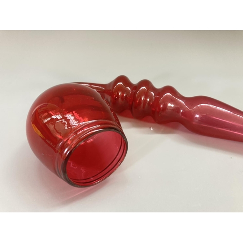 208 - A 19th century Nailsea style cranberry glass pipe - approx. 44cm long