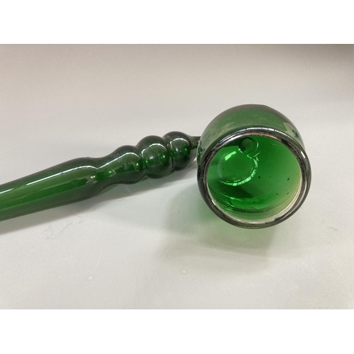 215 - A 19th century Nailsea style green glass pipe - approx. 36cm long