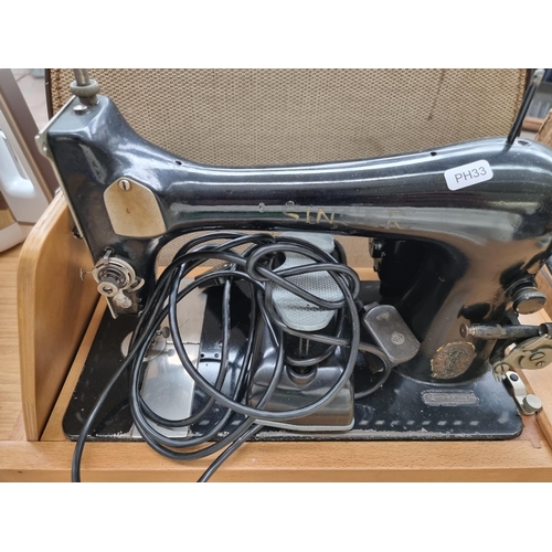 785 - A cased Singer electric sewing machine with light and foot pedal