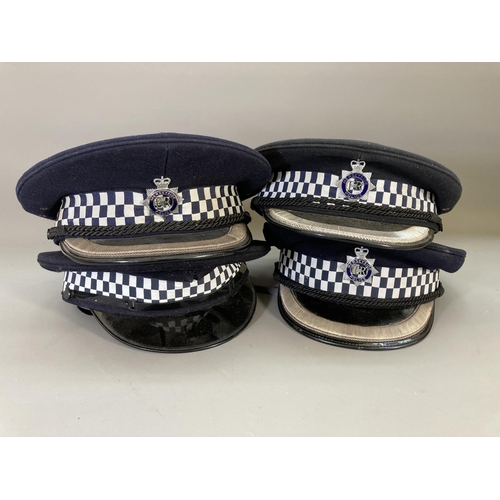 246 - A collection of mid/late 20th century police memorabilia to include four Merseyside Police hats, two... 